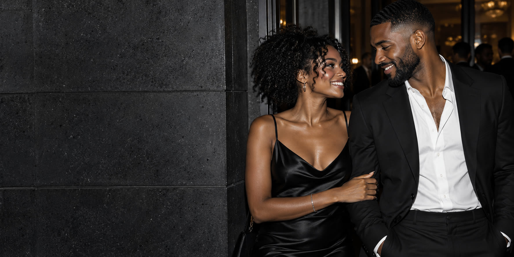 A stylish couple sharing a candid moment before an evening out